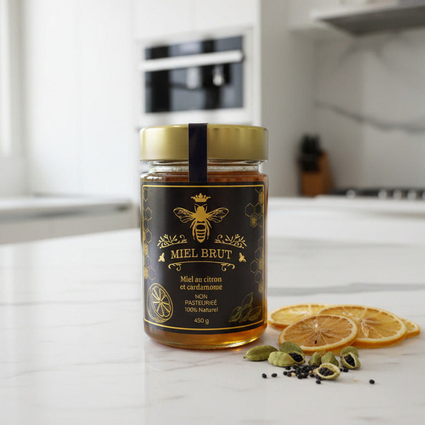 Jar of Mielbrut lemon and cardamom honey on a kitchen counter with dried lemons and cardamom pods