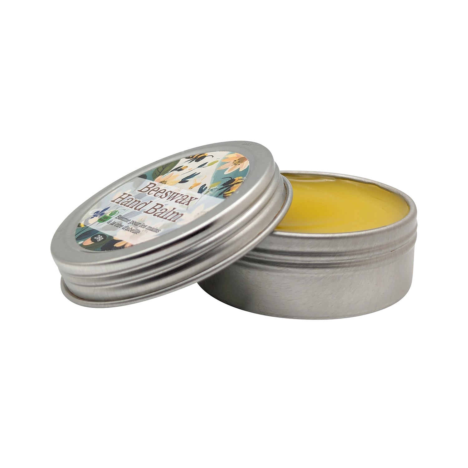 A small, round metal tin with a lid partially removed reveals a solid yellow Honey-Infused Balm inside. The lid has a colorful floral label that reads "Beeswax Balm: Moisturizer for lips, hands, feet and skin" by Mielbrut.com.