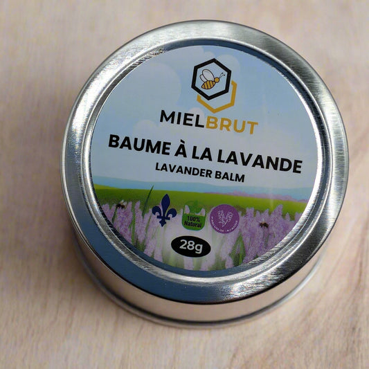 The Mielbrut.com Lavender Beeswax Balm 1oz is presented in a bilingual round tin adorned with bee and lavender imagery. Made from natural ingredients, this soothing beeswax balm offers a 100% natural formula perfect for dry skin relief.